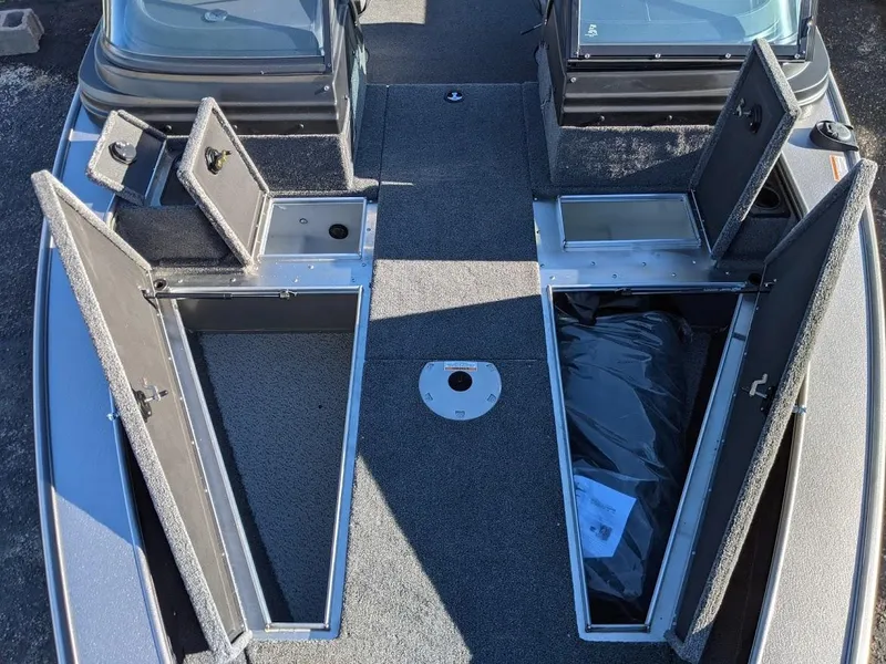 Slide: The Image of 2025 Lund 2075 Pro V Sport boat with open storage compartments. - 4