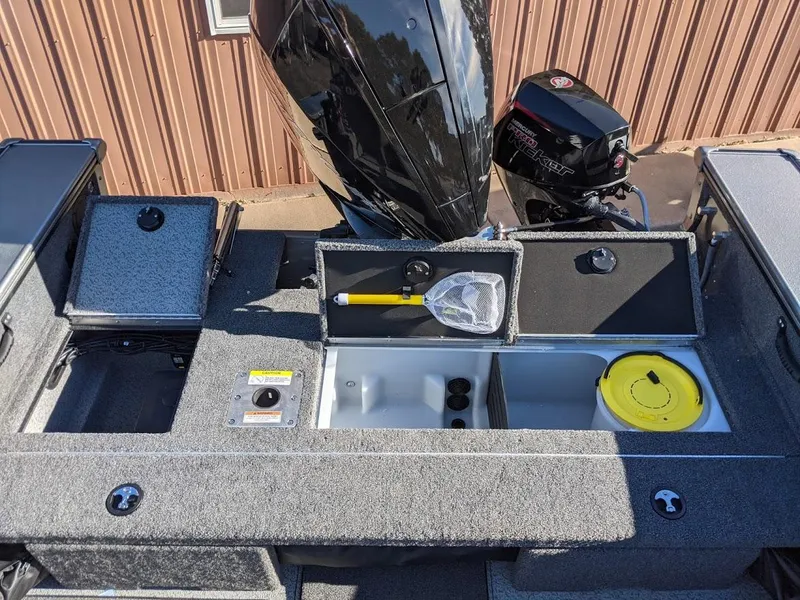 Slide: The Image of 2025 Lund 2075 Pro V Sport boat with open storage compartments and fishing gear. - 6