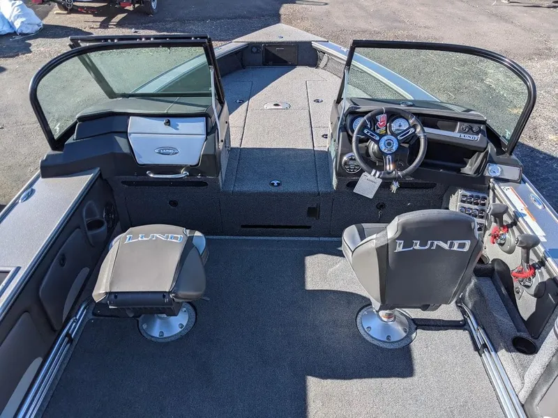 Slide: The Image of 2025 Lund 2075 Pro V Sport boat interior with steering console and seating. - 7