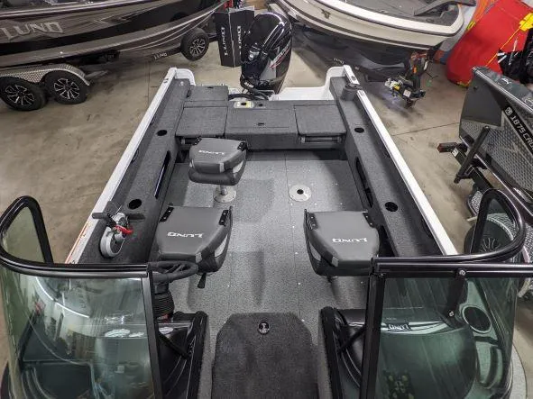 Slide: The Image of 2024 Lund 1775 Adventure Sport fishing boat interior with seating and storage. - 2
