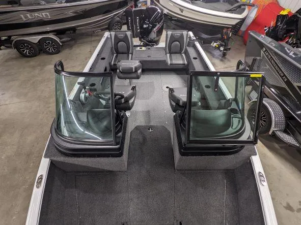 Slide: The Image of 2024 Lund 1775 Adventure Sport fishing boat interior with seating and windshield. - 3