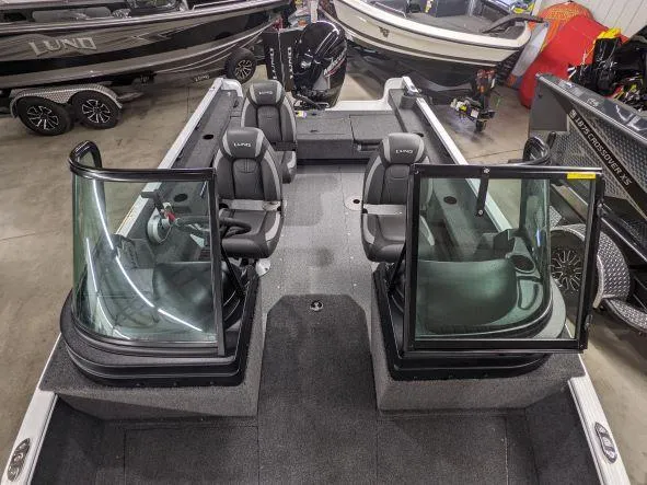 Slide: The Image of 2024 Lund 1775 Adventure Sport boat interior with seating and windshield. - 4