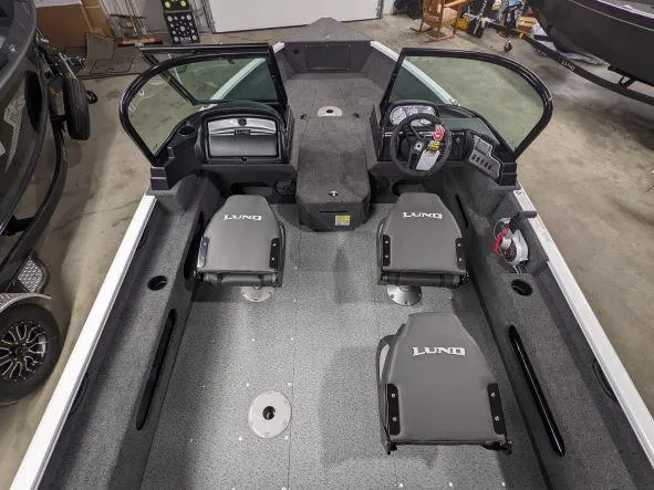 Slide: The Image of 2024 Lund 1775 Adventure Sport boat interior with seating and dashboard. - 7