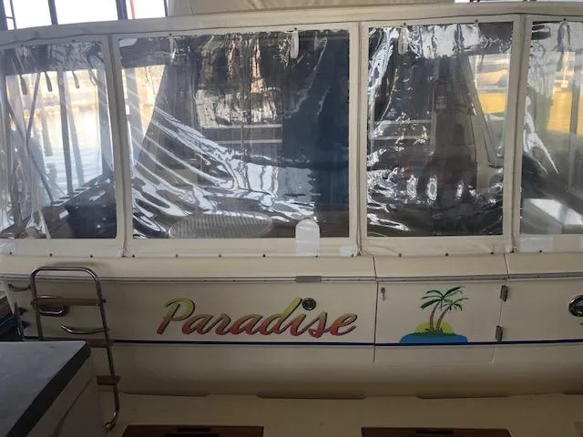 Slide: The Image of 1983 Sea Ray 390 Sport Fisherman boat named Paradise with clear plastic windows. - 1