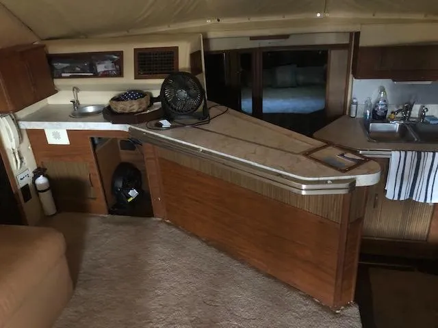 Slide: The Image of Interior of 1983 Sea Ray 390 Sport Fisherman with kitchen and bar area. - 15