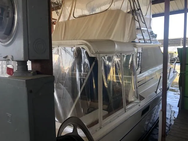Slide: The Image of 1983 Sea Ray 390 Sport Fisherman docked in a covered marina. - 2