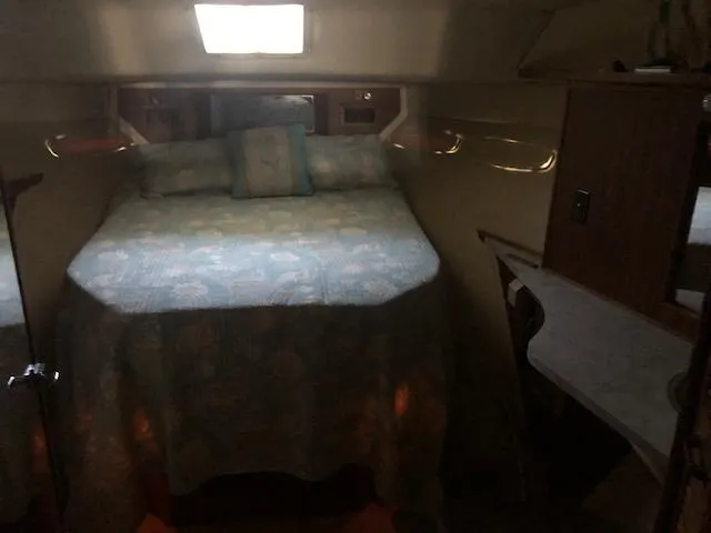 Slide: The Image of 1983 Sea Ray 390 Sport Fisherman cabin interior with bed and skylight. - 25