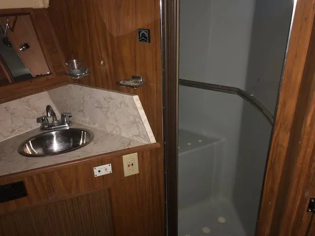 Slide: The Image of 1983 Sea Ray 390 Sport Fisherman bathroom with sink and shower. - 27