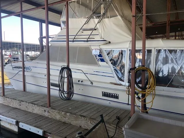 Slide: The Image of 1983 Sea Ray 390 Sport Fisherman docked in a covered marina. - 3