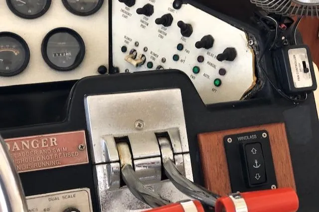 Slide: The Image of Control panel of a 1983 Sea Ray 390 Sport Fisherman boat with throttle levers and gauges. - 32