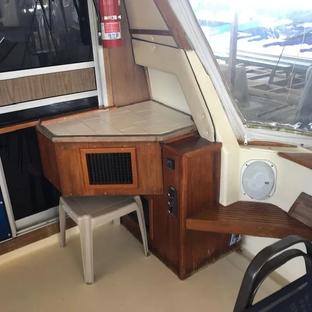 Slide: The Image of 1983 Sea Ray 390 Sport Fisherman interior with wooden cabinetry and seating area. - 4