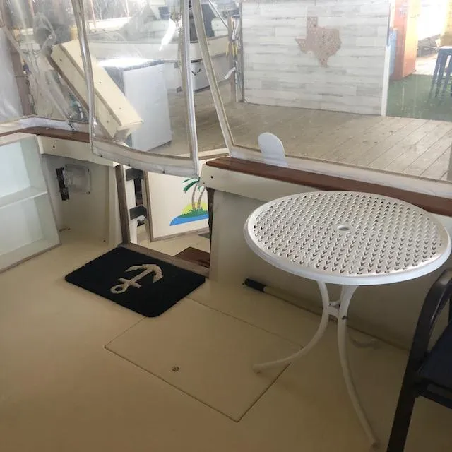 Slide: The Image of 1983 Sea Ray 390 Sport Fisherman interior with table and anchor mat. - 6
