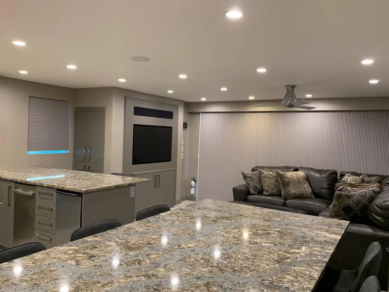 Slide: The Image of Modern kitchen and living area in 2019 Adonia Rhapsody Share #11 with granite countertops and cozy seating. - 2