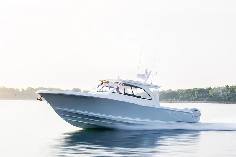 The Image of 2024 Southport 33 DC boat cruising on calm water. - 0