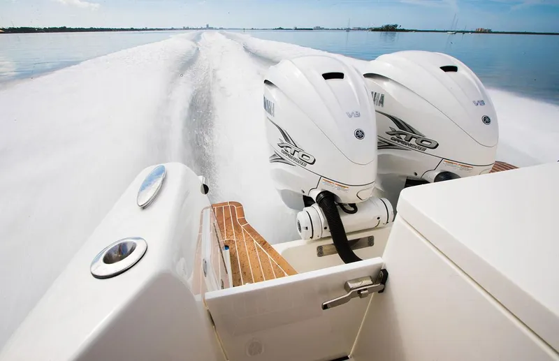 Slide: The Image of 2024 Southport 33 DC boat with twin Yamaha outboard engines on water. - 2
