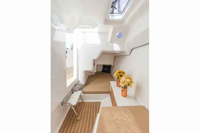 Slide: The Image of Interior cabin of 2024 Southport 33 DC boat with cozy seating and floral decor. - 6