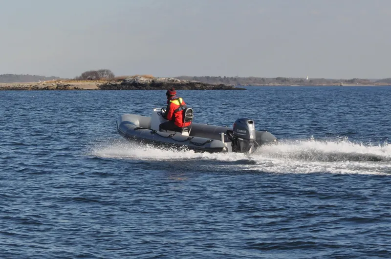 Slide: The Image of 2024 Ribcraft 4.8 Coach boat cruising on open water. - 3