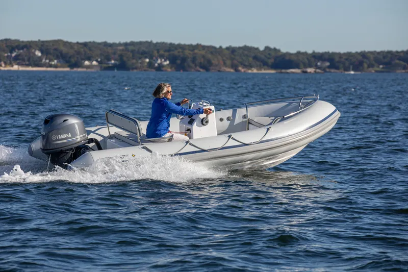 Slide: The Image of 2024 Ribcraft 4.8T boat cruising on water with Yamaha outboard motor. - 1
