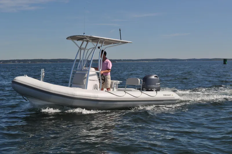 Slide: The Image of 2024 Ribcraft 5.85 boat cruising on open water. - 2
