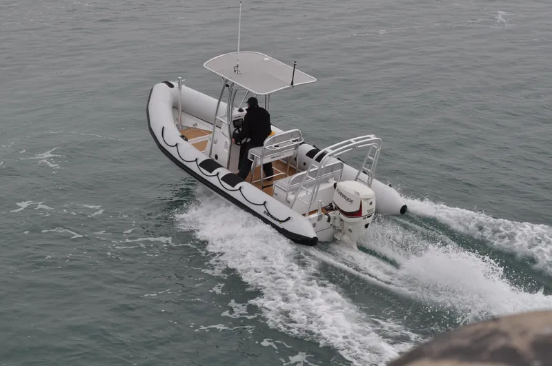 Slide: The Image of 2024 Ribcraft 6.5 boat cruising on water. - 2