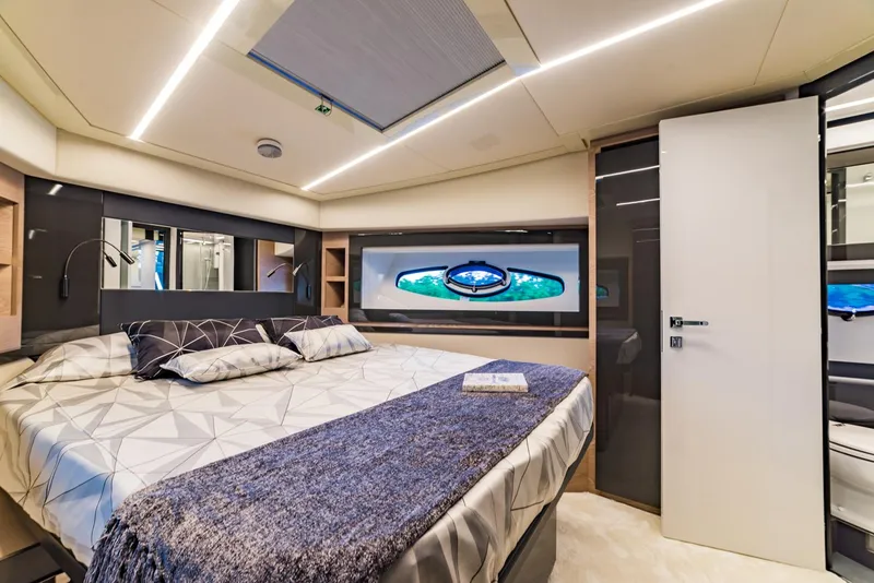 Slide: The Image of Luxurious bedroom interior of 2018 Pershing 70 yacht with modern design and ambient lighting. - 16