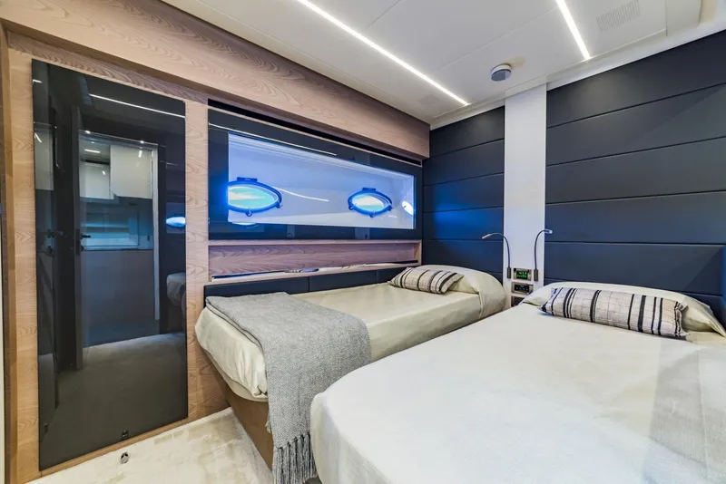 Slide: The Image of Luxurious twin bedroom on a 2018 Pershing 70 yacht with modern decor. - 21