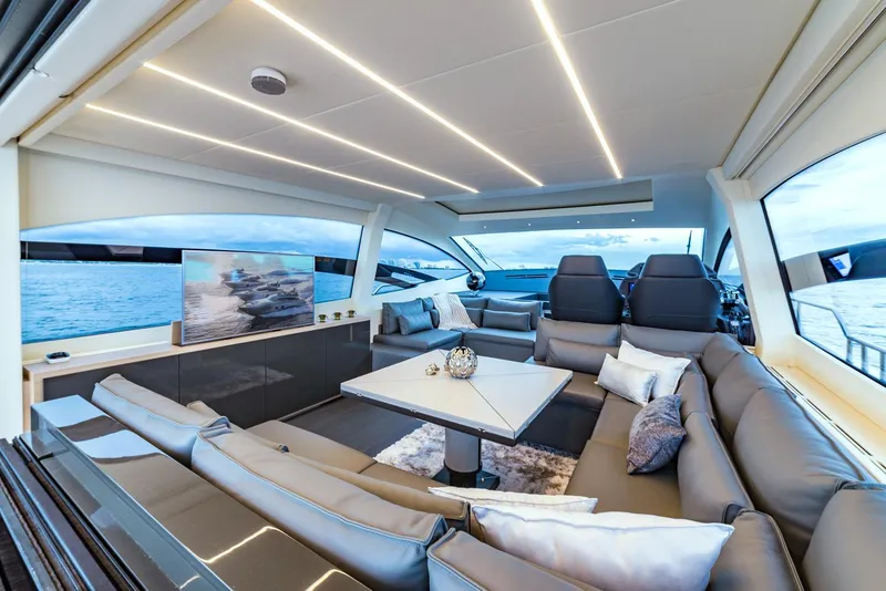 Slide: The Image of Luxurious interior of 2018 Pershing 70 yacht with modern seating and panoramic windows. - 5