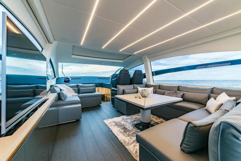 Slide: The Image of Luxurious interior of a 2018 Pershing 70 yacht with modern seating and panoramic windows. - 6