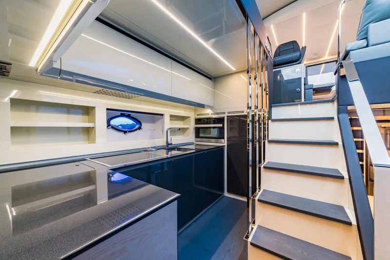 Slide: The Image of Modern kitchen interior of 2018 Pershing 70 yacht with sleek design and staircase. - 8