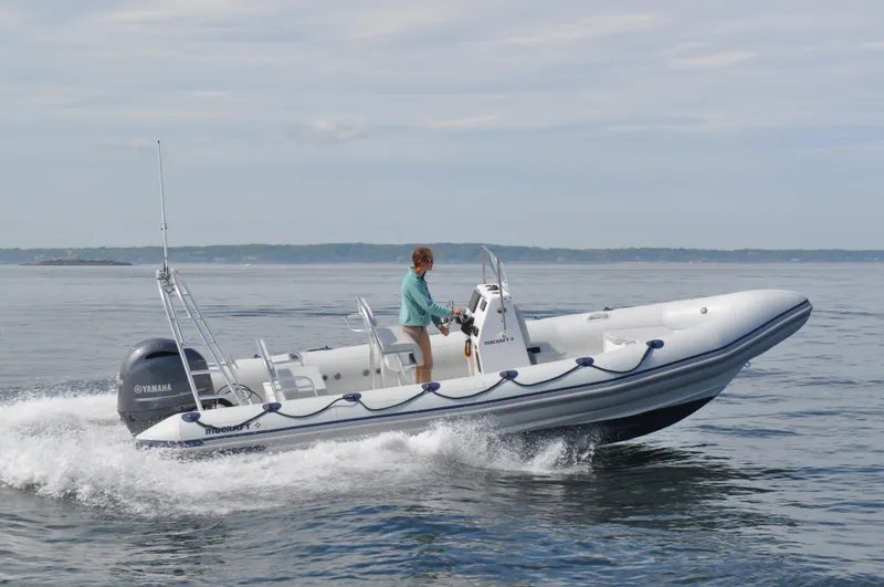 Slide: The Image of 2024 Ribcraft 6.8 inflatable boat cruising on calm water. - 3