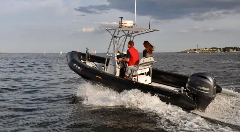 Slide: The Image of 2024 Ribcraft 6.8 boat cruising on open water with two passengers. - 4