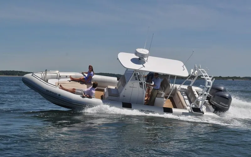 Slide: The Image of 2024 Ribcraft 9.0 boat cruising on water with passengers enjoying the ride. - 2