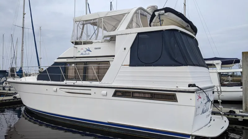 Slide: The Image of 1992 Jefferson 43 Sun Deck yacht docked at marina. - 1