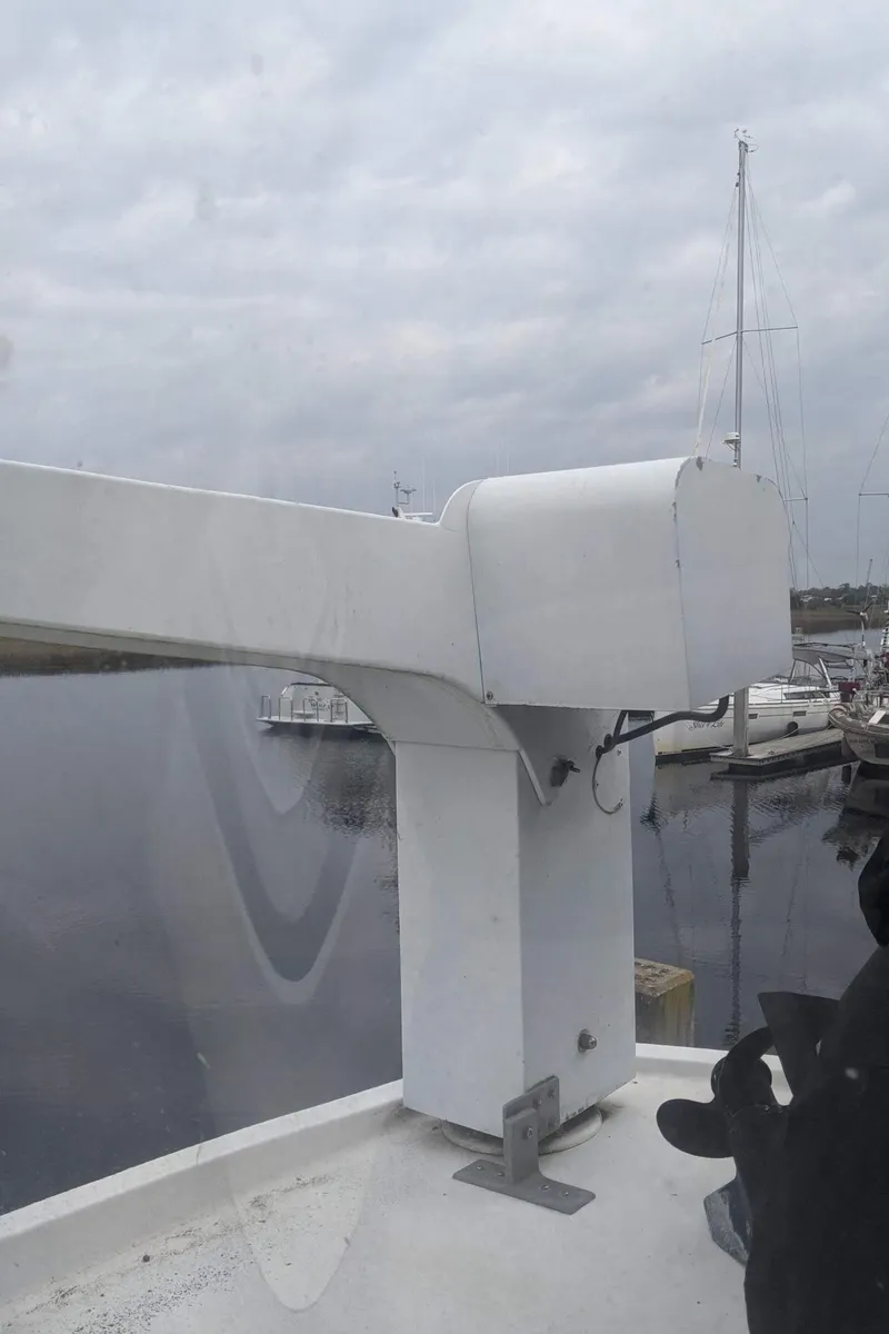 Slide: The Image of 1992 Jefferson 43 Sun Deck yacht in harbor under cloudy sky. - 12