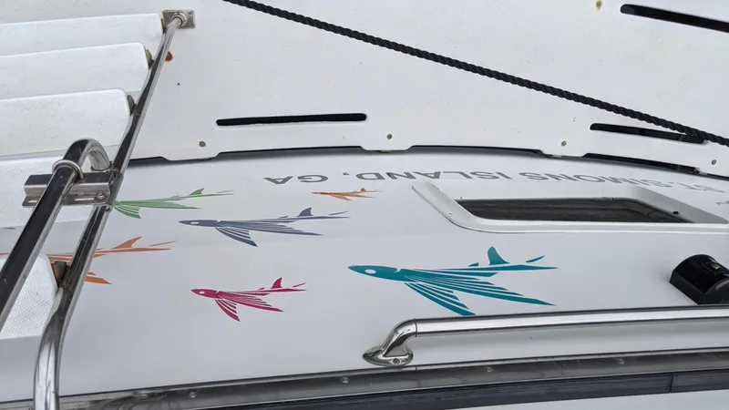 Slide: The Image of 1992 Jefferson 43 Sun Deck with colorful fish decals on deck. - 15