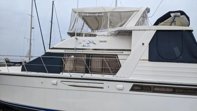 Slide: The Image of 1992 Jefferson 43 Sun Deck yacht docked at harbor. - 2