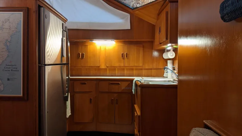 Slide: The Image of Interior of 1992 Jefferson 43 Sun Deck yacht with kitchen and wood paneling. - 33