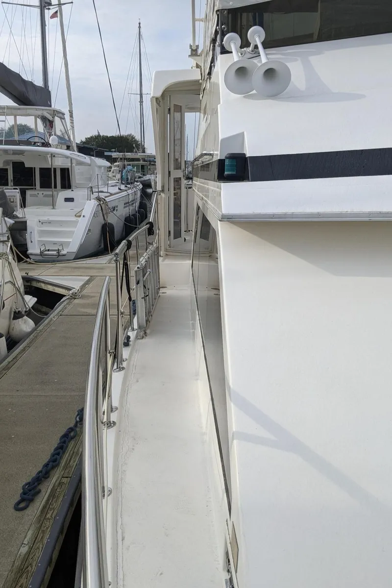 Slide: The Image of 1992 Jefferson 43 Sun Deck yacht in harbor, side view. - 4