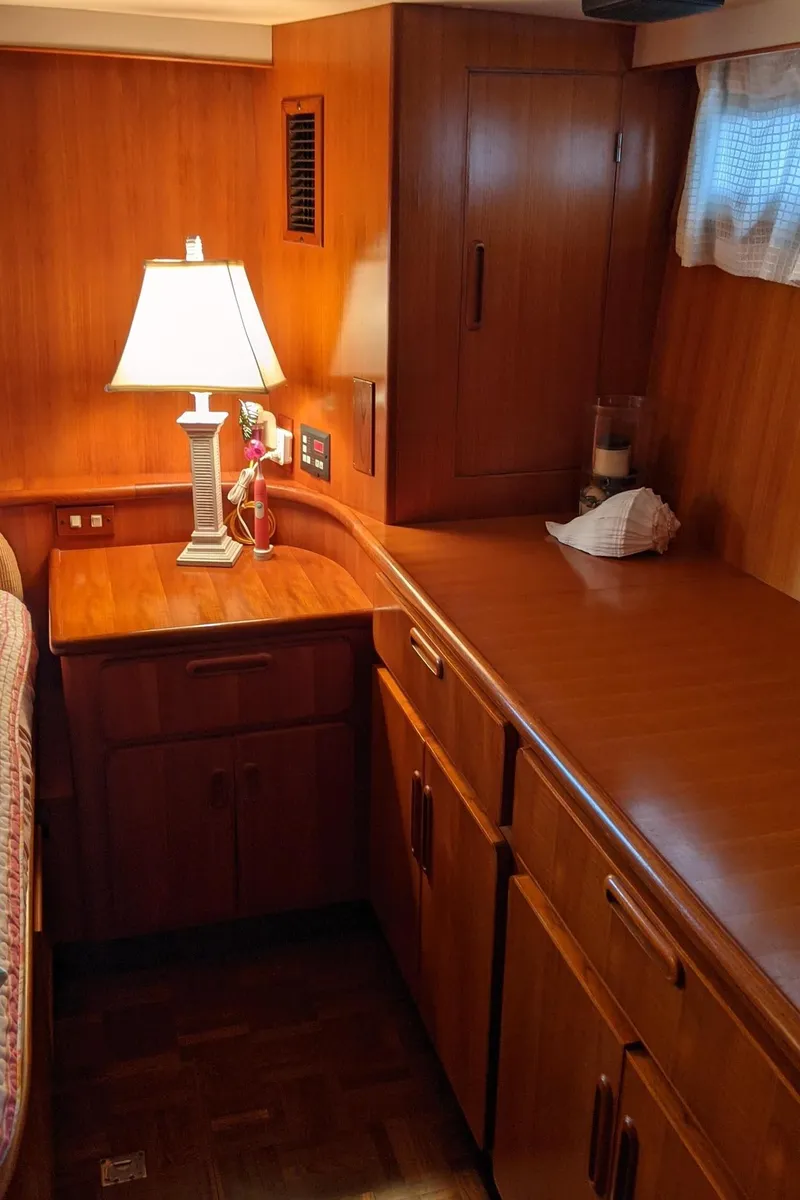 Slide: The Image of Interior of 1992 Jefferson 43 Sun Deck yacht with wooden cabinets and lamp. - 41