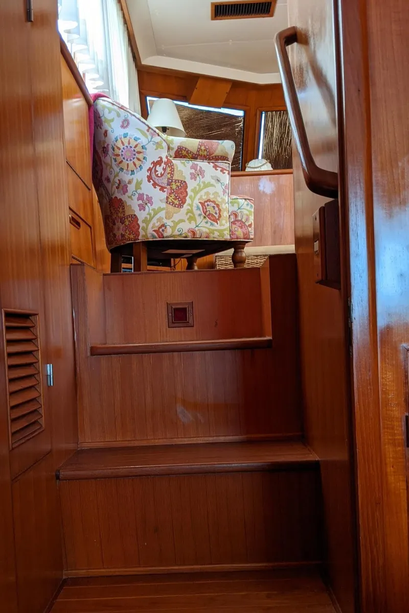 Slide: The Image of Interior of a 1992 Jefferson 43 Sun Deck yacht with wooden stairs. - 48