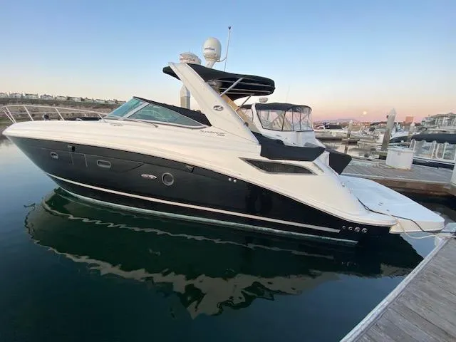 The Image of 2015 Sea Ray 350 Sundancer yacht docked at marina during sunset. - 0