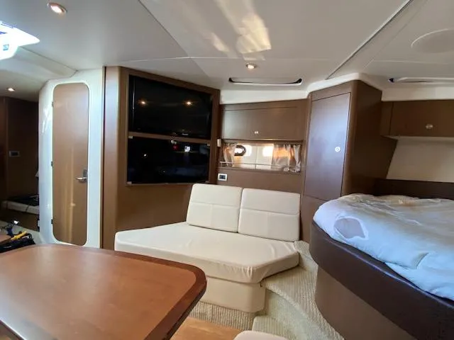 Slide: The Image of Interior of 2015 Sea Ray 350 Sundancer yacht with cozy seating and modern amenities. - 10