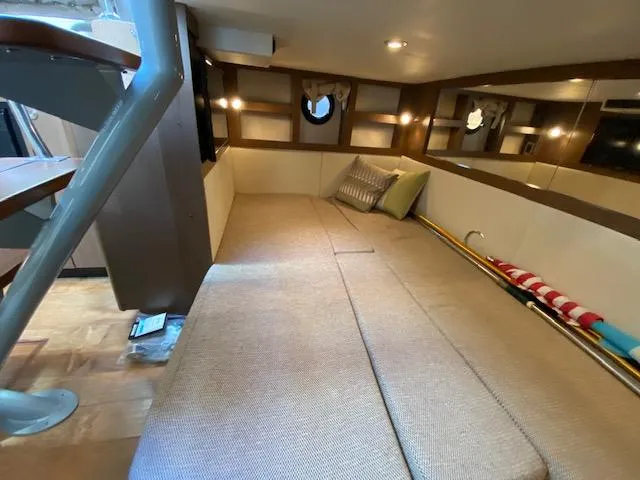 Slide: The Image of Interior cabin of 2015 Sea Ray 350 Sundancer with cozy seating and modern design. - 13