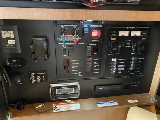Slide: The Image of Control panel of a 2015 Sea Ray 350 Sundancer boat with various switches and gauges. - 17