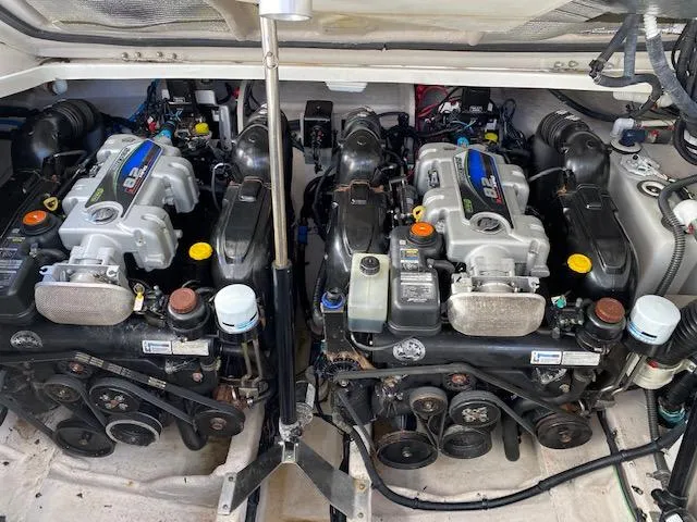 Slide: The Image of Twin engines of a 2015 Sea Ray 350 Sundancer boat, showcasing detailed mechanical components. - 18