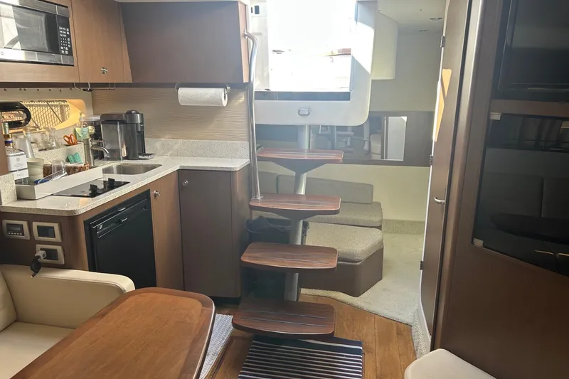 Slide: The Image of Interior of 2015 Sea Ray 350 Sundancer yacht with modern kitchen and wooden stairs. - 24