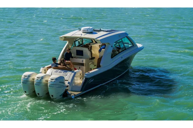 Slide: The Image of 2023 Scout 350 LXZ boat cruising on clear blue water. - 12