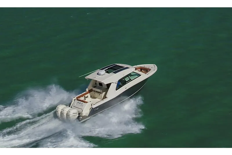 Slide: The Image of 2023 Scout 350 LXZ boat cruising on open water. - 16