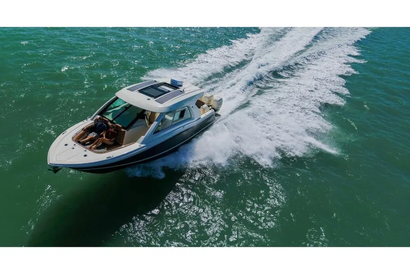 Slide: The Image of 2023 Scout 350 LXZ boat cruising on open water. - 17