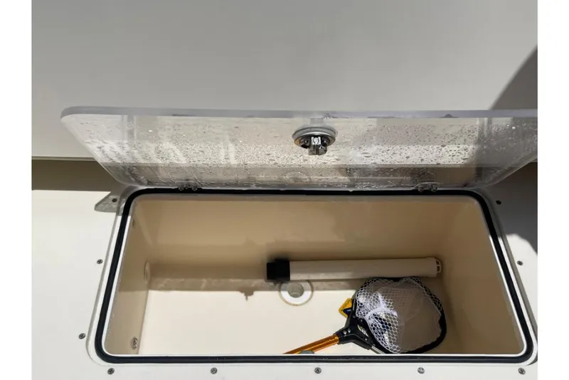 Slide: The Image of 2023 Scout 350 LXZ storage compartment with fishing net and rod holder. - 24